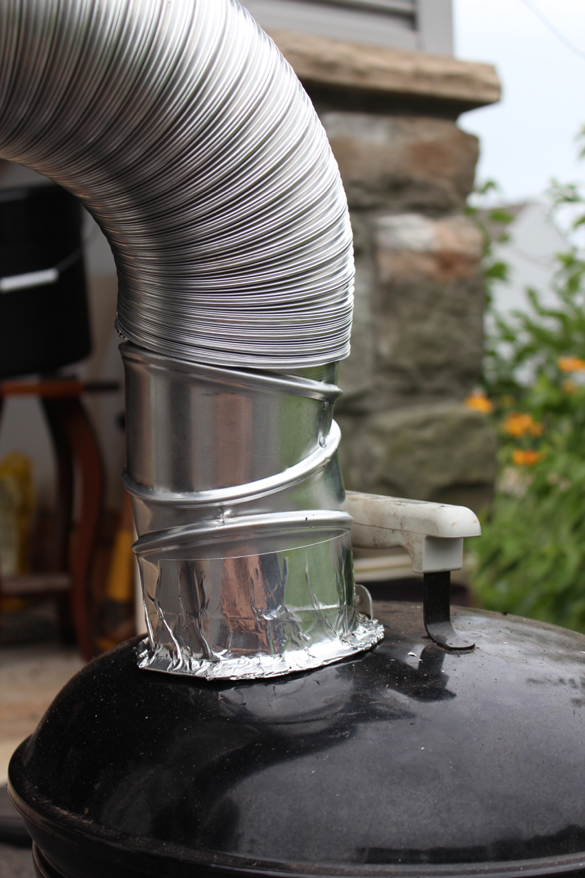 Close-up detail of the smoke conduit leading from the "Smokey Joe" grill.